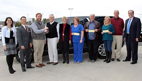 photo: individuals listed in caption standing in front of vehicle