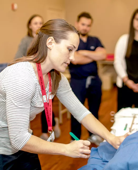 Instructor performing a demonstration for students